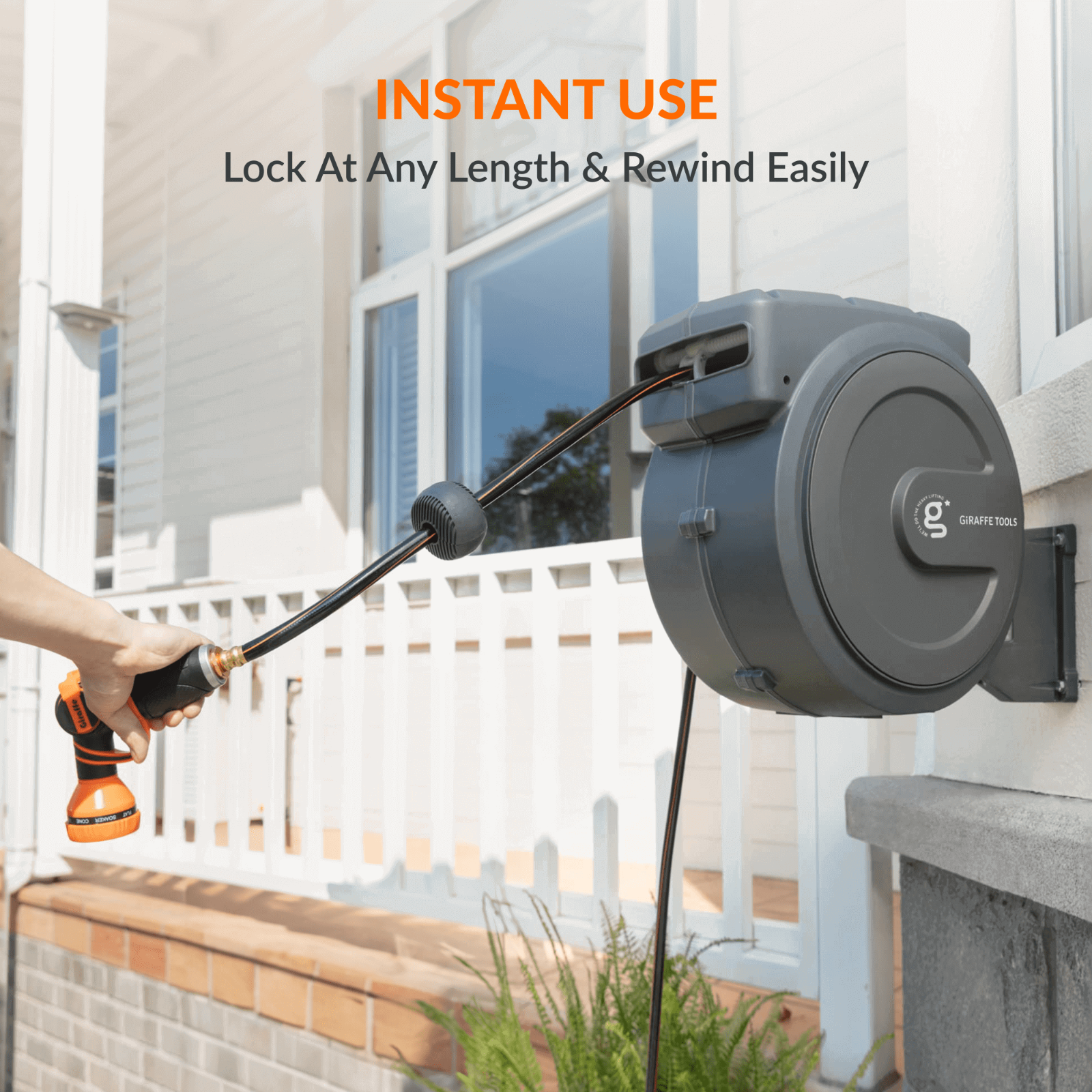 Retractable garden hose reel with adjustable lock mechanism installed on an exterior wall of a home with text noting features of lock at any length and rewind easy.