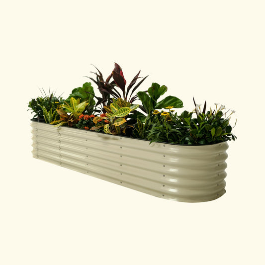A pearl white self-watering Garden Bed with colorful flowers and plants on a white background.