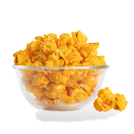 Sour Cream and Cheddar Popcorn popped in a bowl on a white background