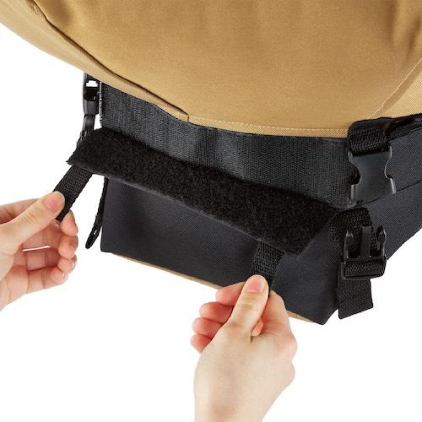 Close-up of a person adjusting the compost bag attached to the bottom of an Urban Worm Bag on a white background. 