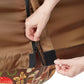 Close-up of a person adjusting a zipper on the Urban Worm Bag Weather Cover on a white background.