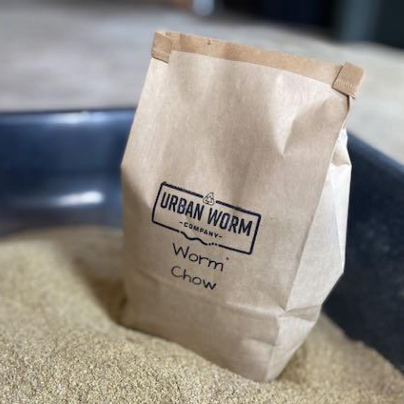 Bag of Urban Worm Company Worm Chow on a container of Chow.