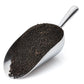 Metal scoop filled with worm castings on a white background