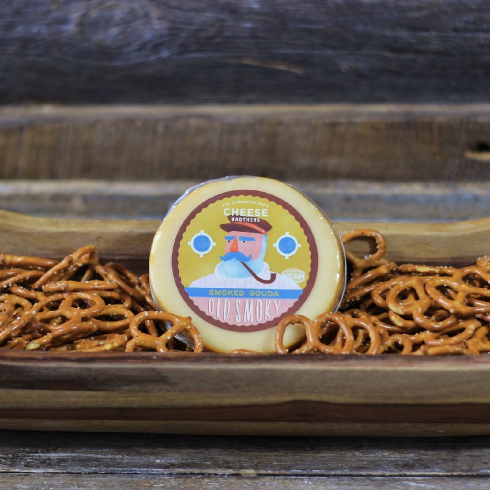 Smoked Gouda Cheese Block presented in a serving bowl with pretzels