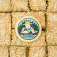 Bourbon Gouda block of cheese presented on multiple mini straw bales