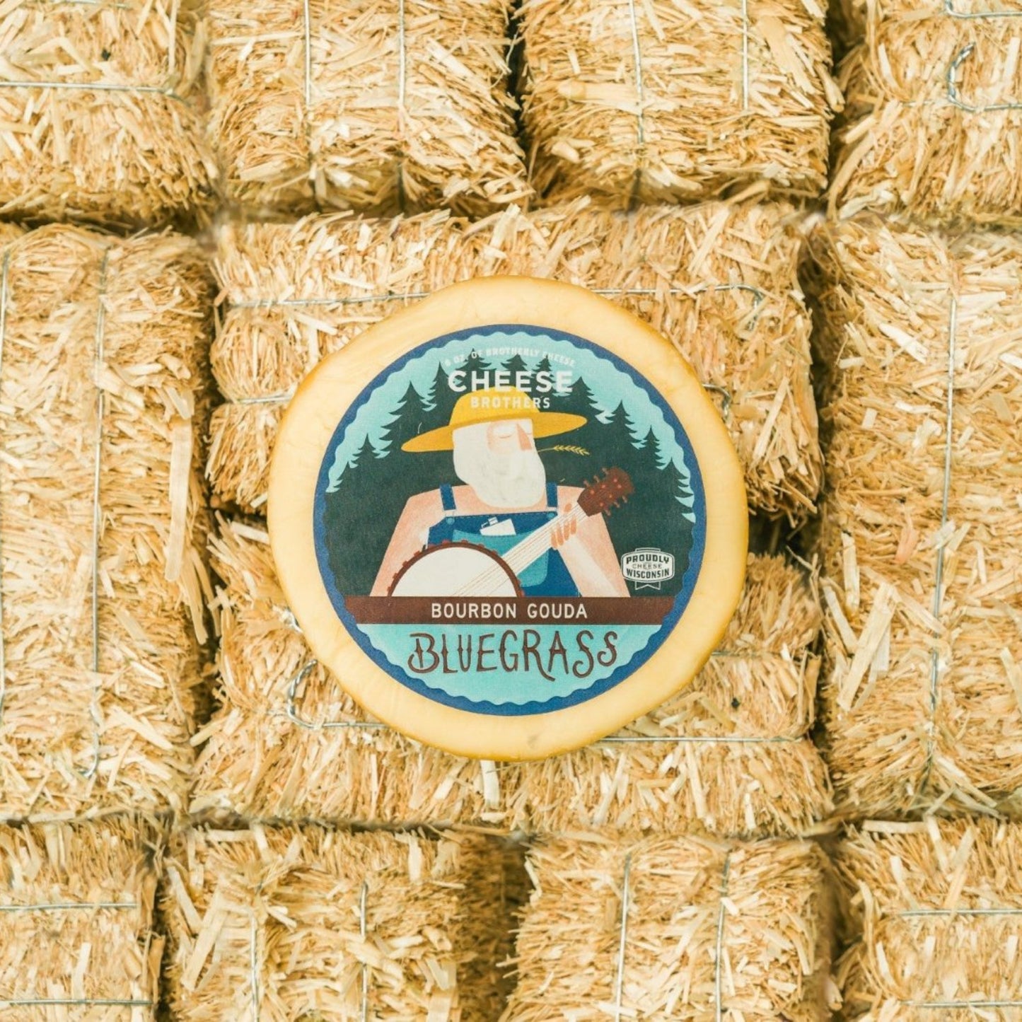 Bourbon Gouda block of cheese presented on multiple mini straw bales