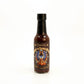 Chipotle Ghost & Black Garlic Hot Sauce on white background
