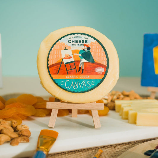 classic gouda cheese packaged surrounded by charcuterie