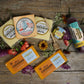 Feel cheddar soon gift box cheeses displayed amongst flowers on wooden tray