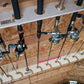 Close-up of both racks with the fishing rod rack stud mount organizer  installed on ceiling studs and fishing rods in the rack.