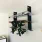 Flush-mounted snowboard rack holding three snowboards with bindings, organized neatly on a black snowboard rack.