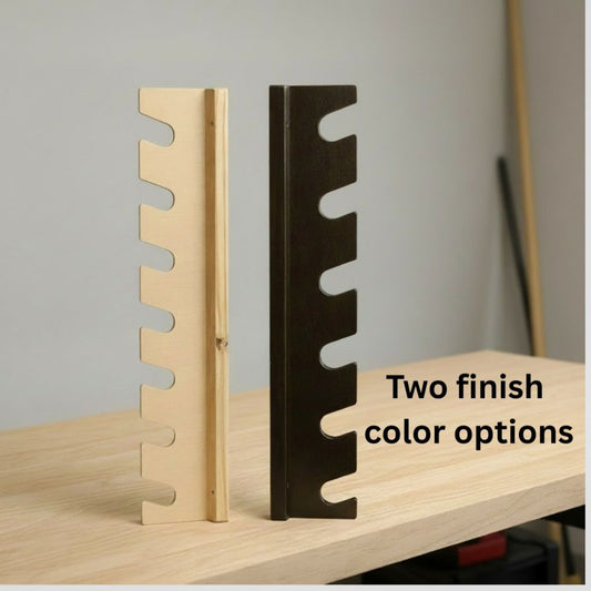 Two of the garden tool rack side panels displayed on a workbench, showing natural wood and black finish options.