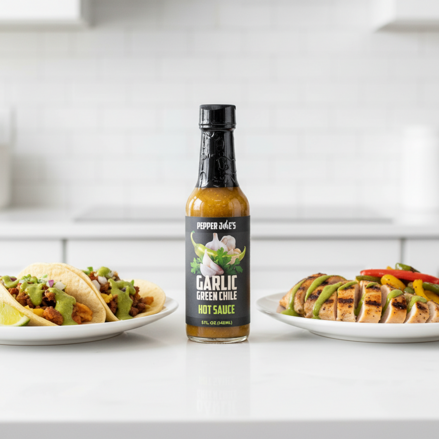 Garlic Green Chile Hot Sauce bottle on a white kitchen counter beside a plate of tacos and a plate of grilled chicken and vegetables drizzled with spicy hot sauce.
