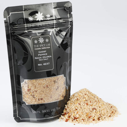 Black packaging with visible spices in the ghost pepper naga jolokia sea salt on a white background