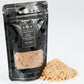 Black packaging with visible spices for the ghost pepper naga jolokia salt on a white background