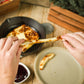 golden baked bliss cheese being pulled apart to show melty cheese texture