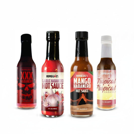 Pepper Joe's Habanero hot sauce gift box  that includes one bottle each of XXX Habanero, Garlic Habanero, Mango Habanero, and Tropical Habanero on a white background