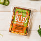 packaged jalapeno golden baked bliss cheese on white table with peppers