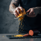 pepper joes carolina reaper cheddar cheese being grated next to reaper summer sausage