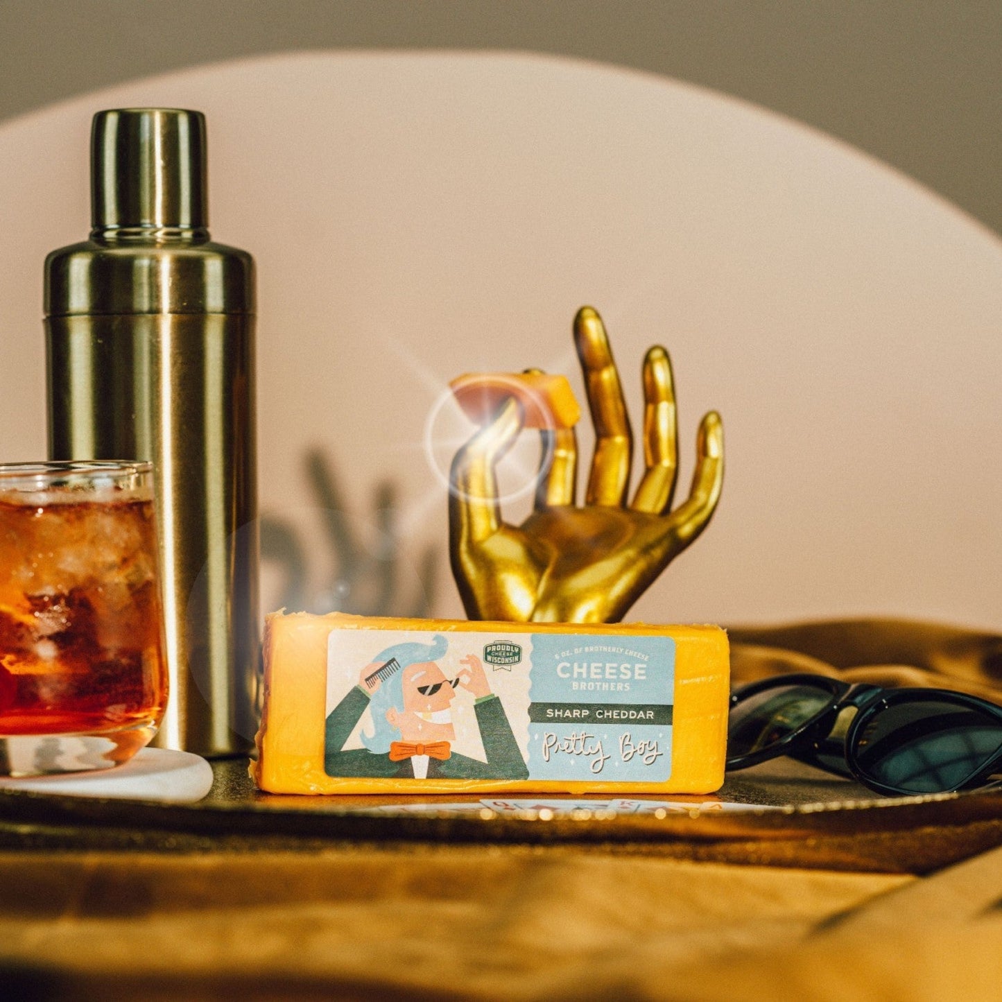 Block of Pretty Boy Sharp Cheddar cheese displayed on a plate