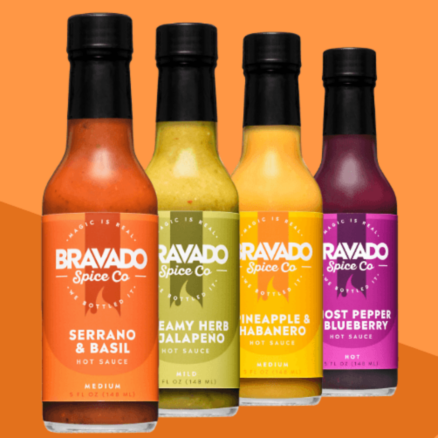 Four bottles of hot sauces on an orange background, including serrano & basil, creamy herb jalapeno, pineapple habanero, and ghost pepper blueberry
