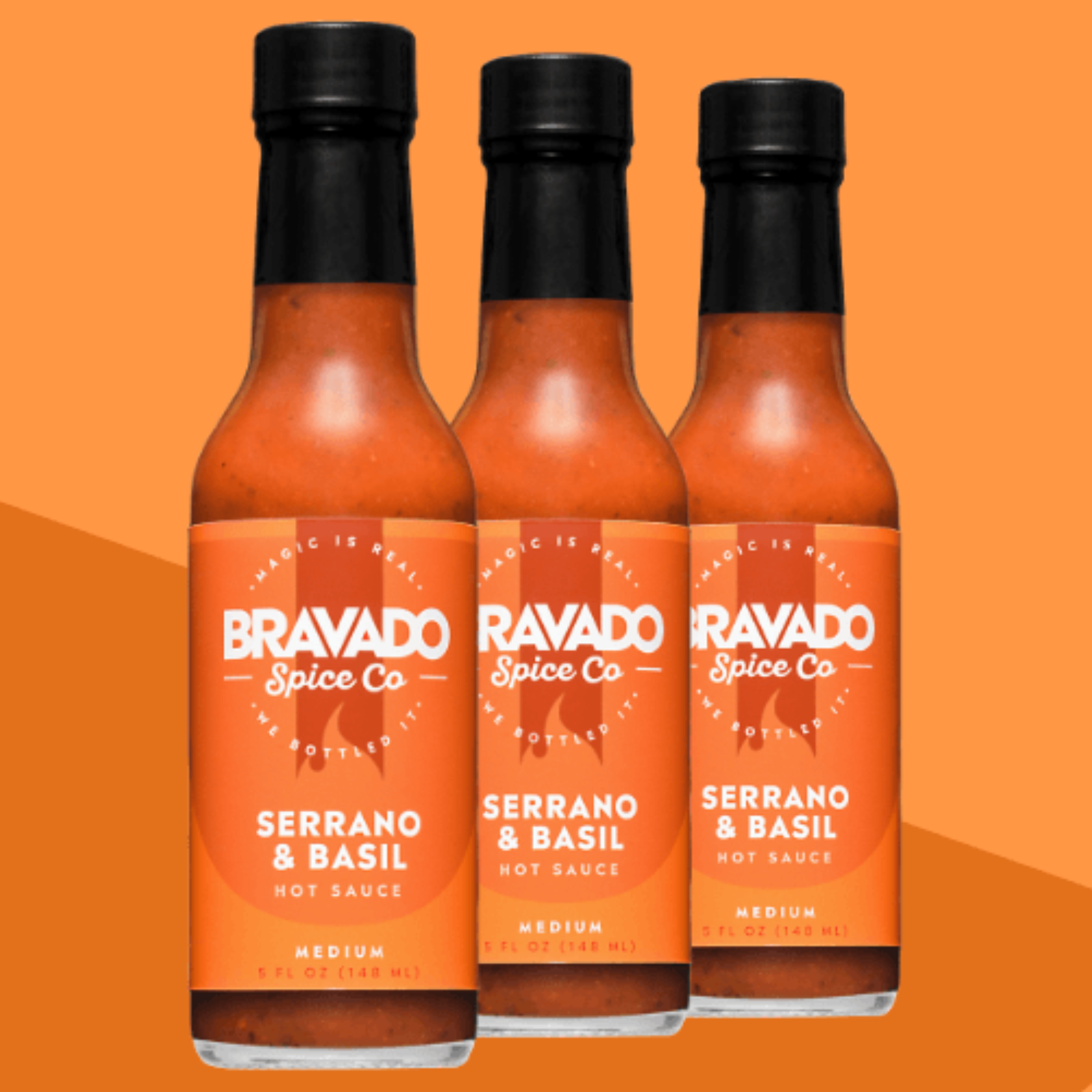 Three bottles of Serrano & Basil hot sauce on an orange background