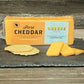 sharp cheddar cheese block on slate cutting board with sliced cheese and crackers