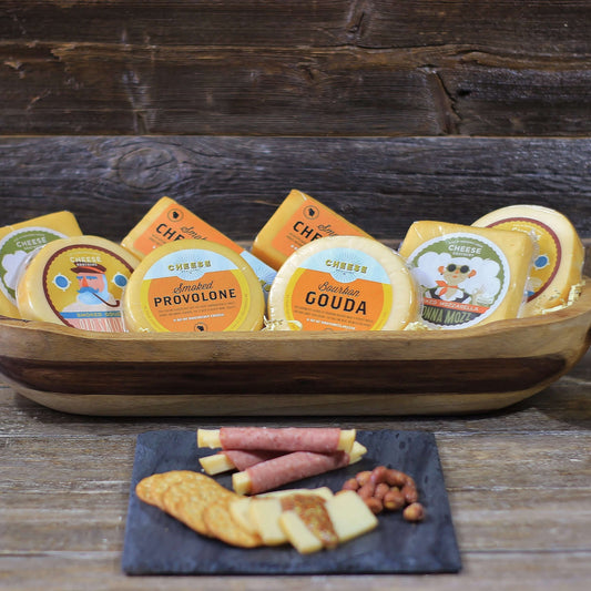 Collection of smoked wisconsin cheeses displayed in wooden bowl