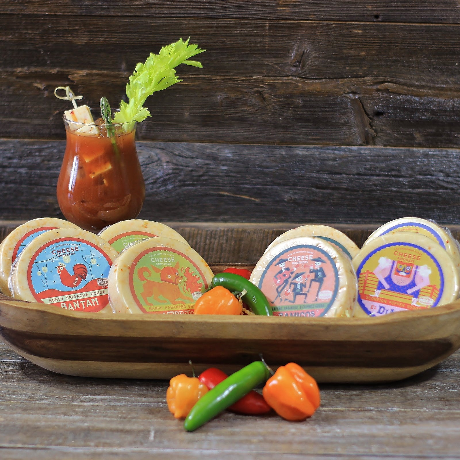 a selection of spicy cheeses displayed in wooden bowl