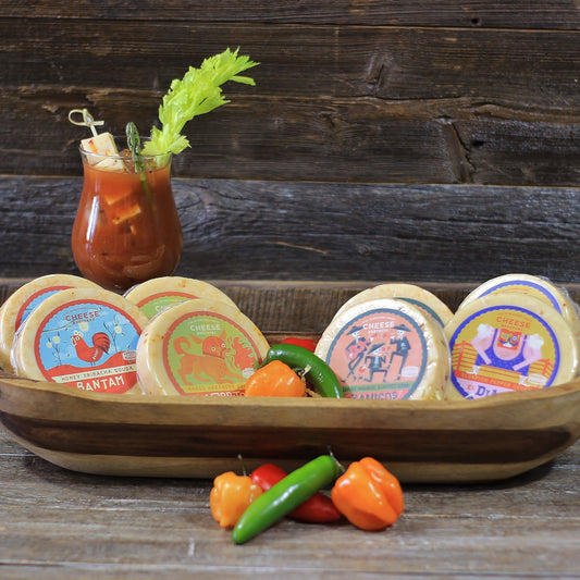 a selection of spicy cheeses displayed in wooden bowl