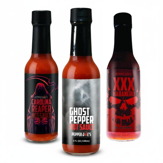 Pepper Joe's Tour of Heat hot sauce gift box  that includes one bottle each of Ghost Pepper, XXX Habanero, and Carolina Reaper on a white background