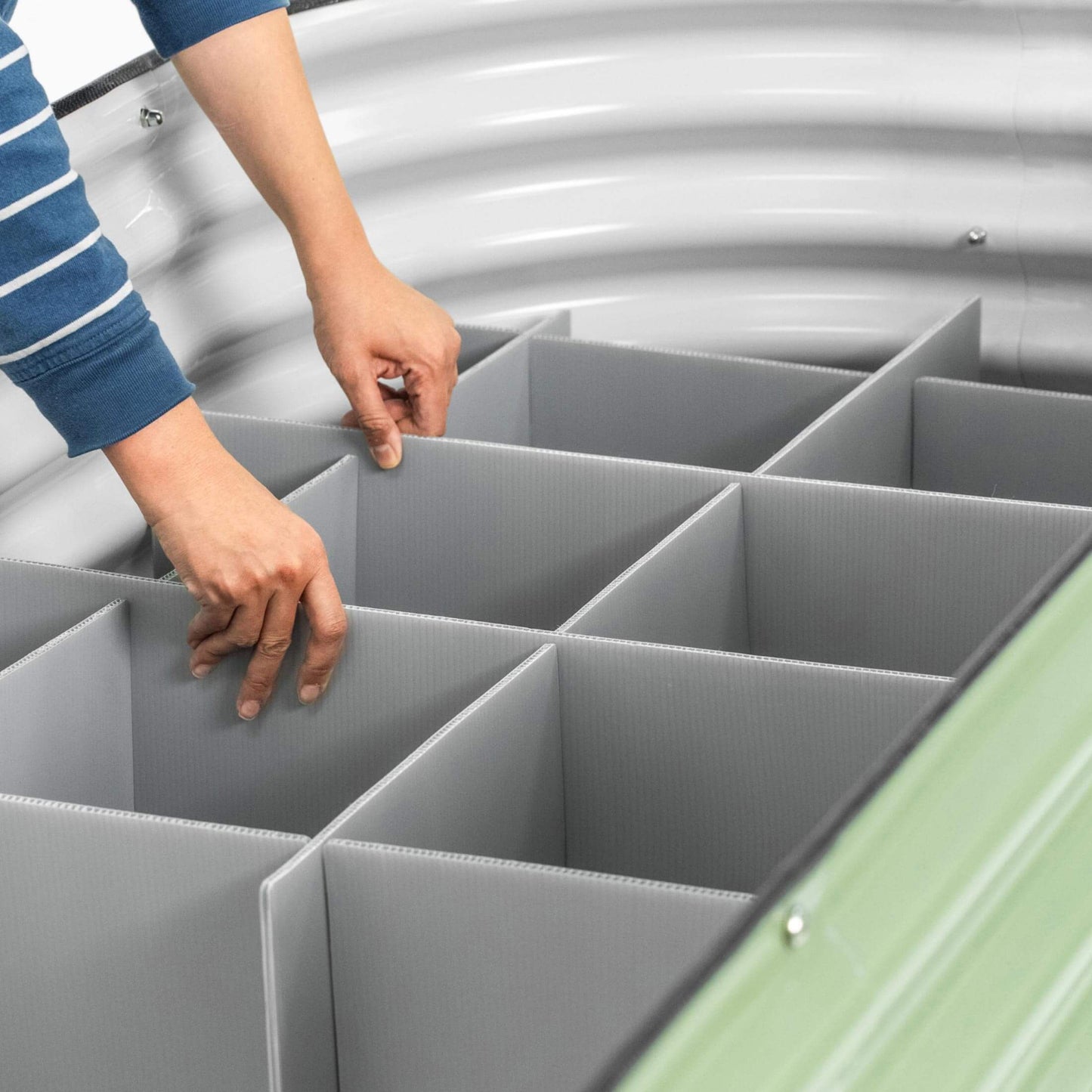 Person installing the numbered boards  of the Soil Saving Floor into a 32 inch raised garden bed. 