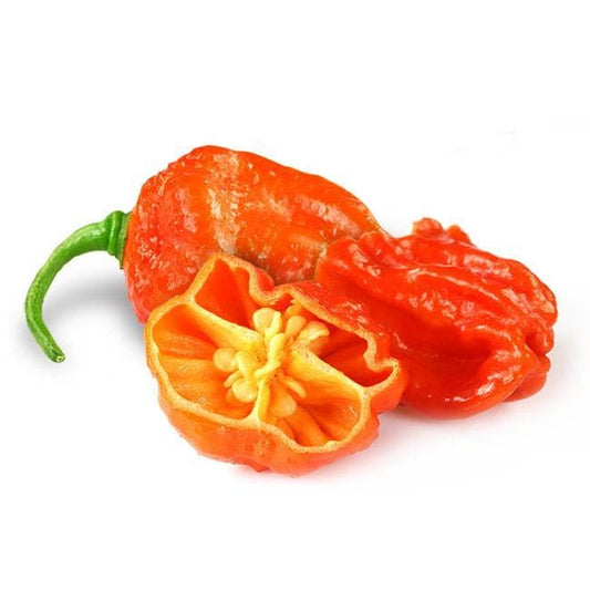 Three orange Dorset Naga Orange Peppers with one cut in half, exposing the seeds inside