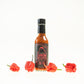 Pepper Joe's Carolina Reaper Hot Sauce Pack - Carolina Reaper hot sauce bottle with red Reapers around sauce