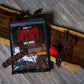 Pepper Joe's Spicy Beef Jerky collection - Carolina Reaper beef jerky bag on wooden table with jerky pieces around