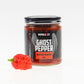 Pepper Joe's Ghost Pepper Mash Puree with Ghost pepper pod next to jar on white background