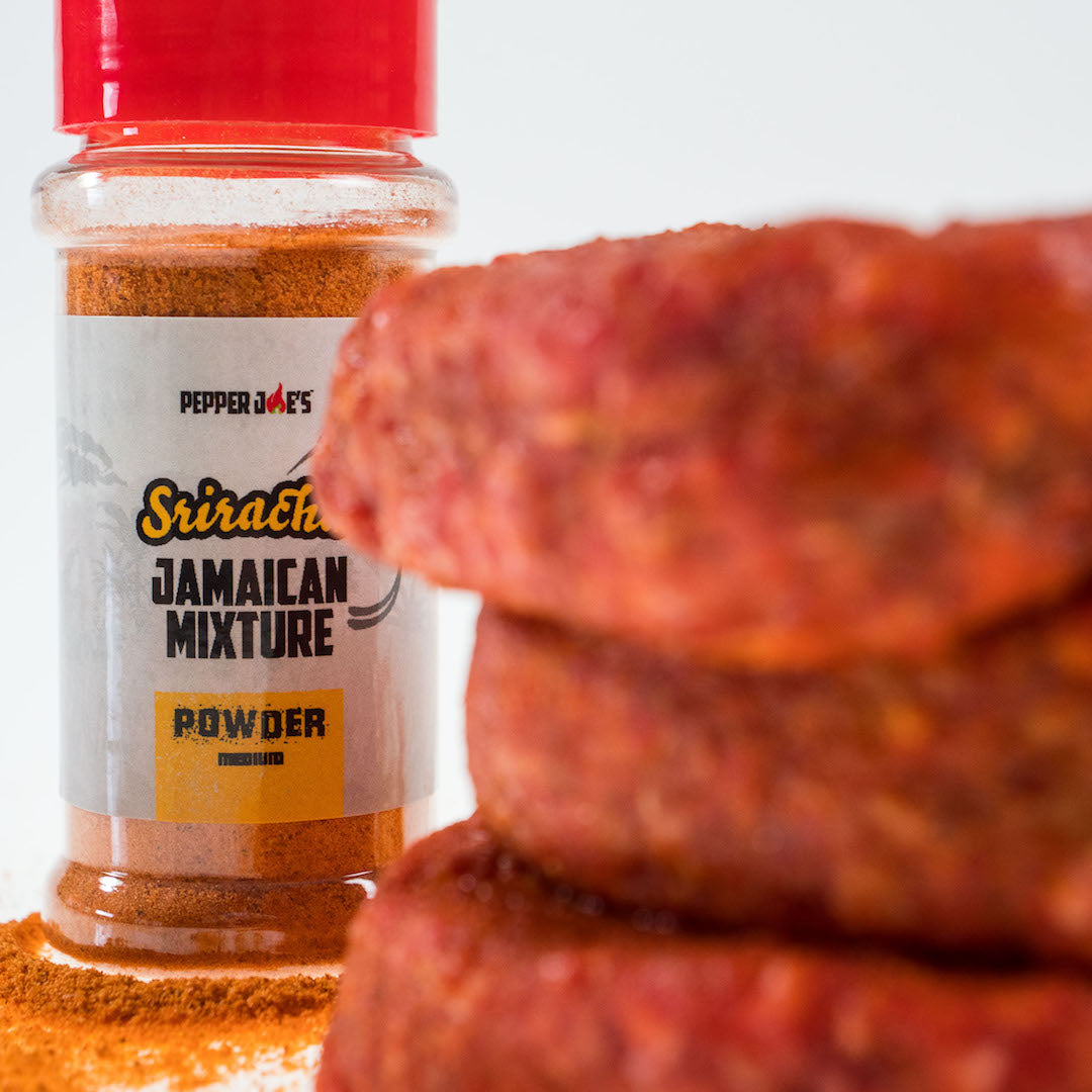 Sriracha Jamaican Pepper Seasoning Spice jar next to raw meat to use as seasoning and marinade