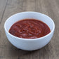 Pepper Joe's spicy ghost pepper ketchup - ketchup spicy in white bowl on wooden table