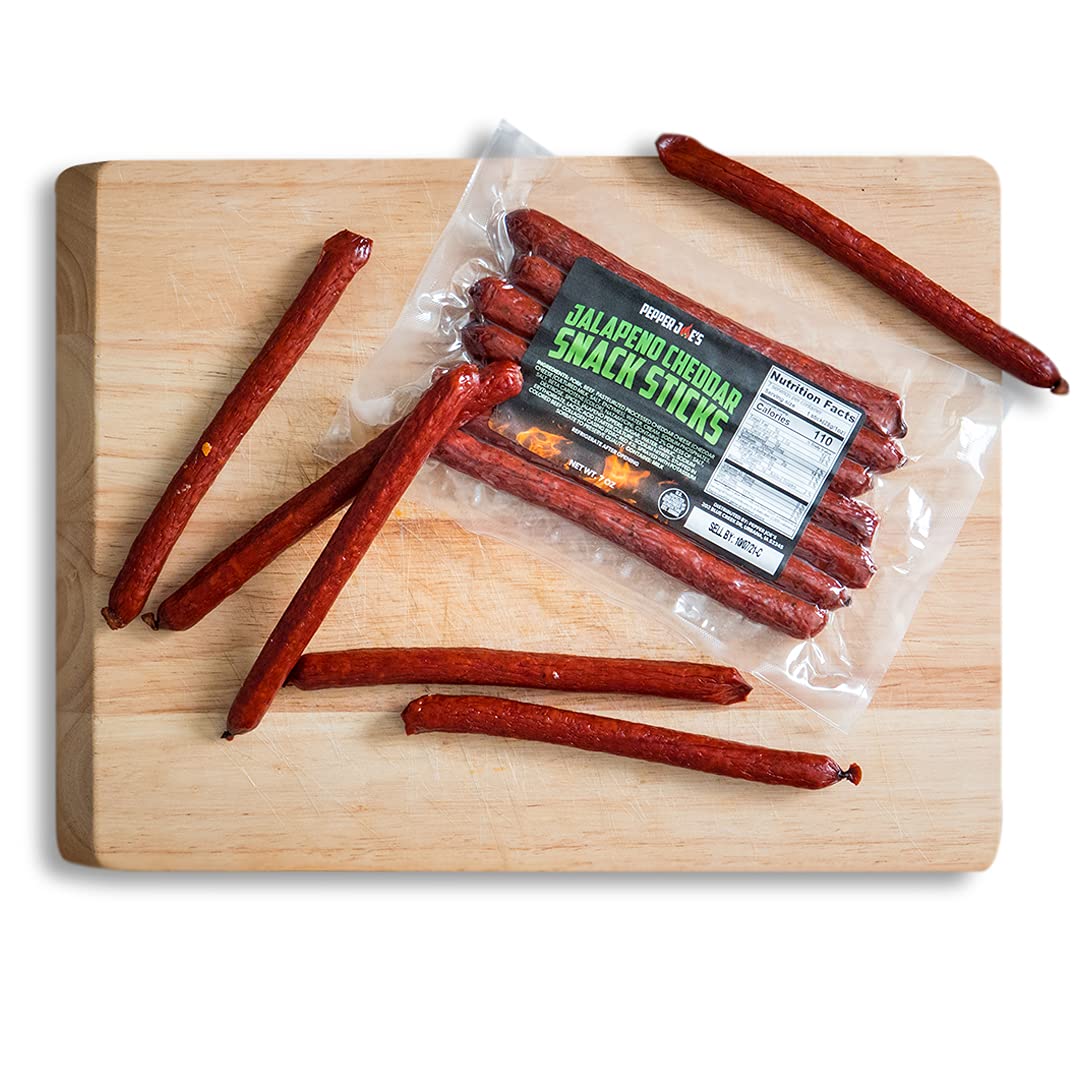 Pepper Joe's Jalapeno Cheddar Snack Sticks - meat snack sticks placed on wooden cutting board on white background