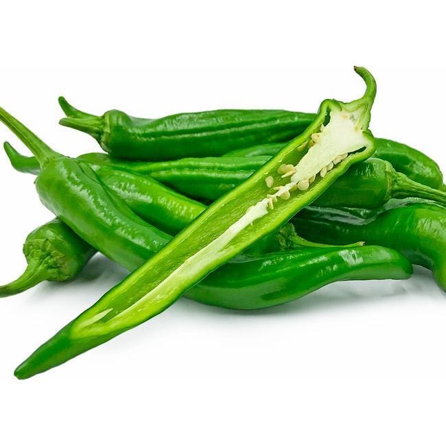 Pile of green Manganji peppers with one cut in half lengthwise