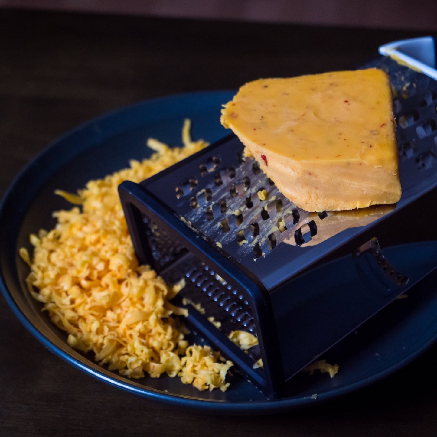 pepper joes Carolina Reaper Cheddar Cheese being shredded