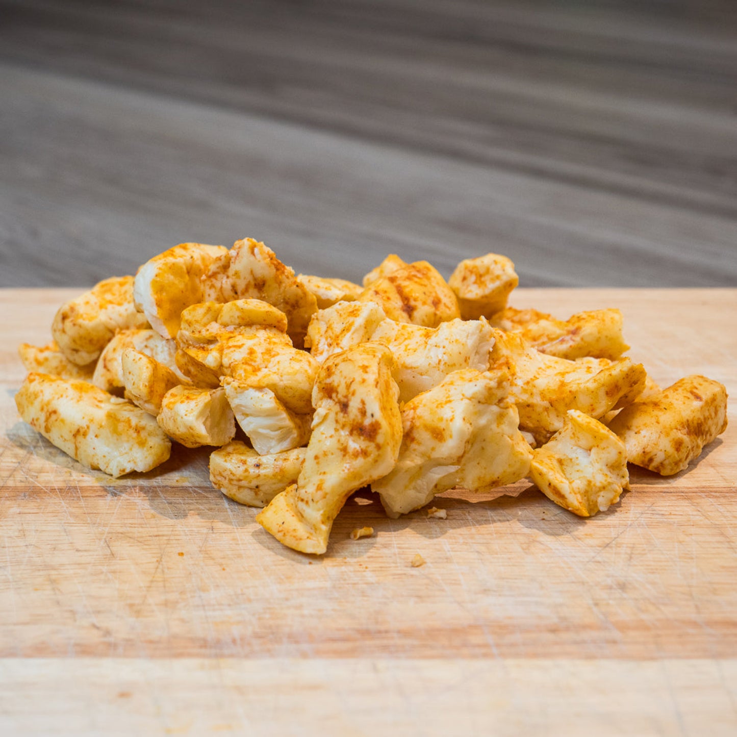 Pepepr Joe's Ghost Pepper Cheese Curds displayed on wood cutting board 