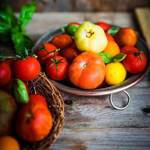 Tomato Garden Seeds 8-Pack – Pepper Joe’s Exclusive Tomato seeds– stock image of different colored tomatoes on wooden table