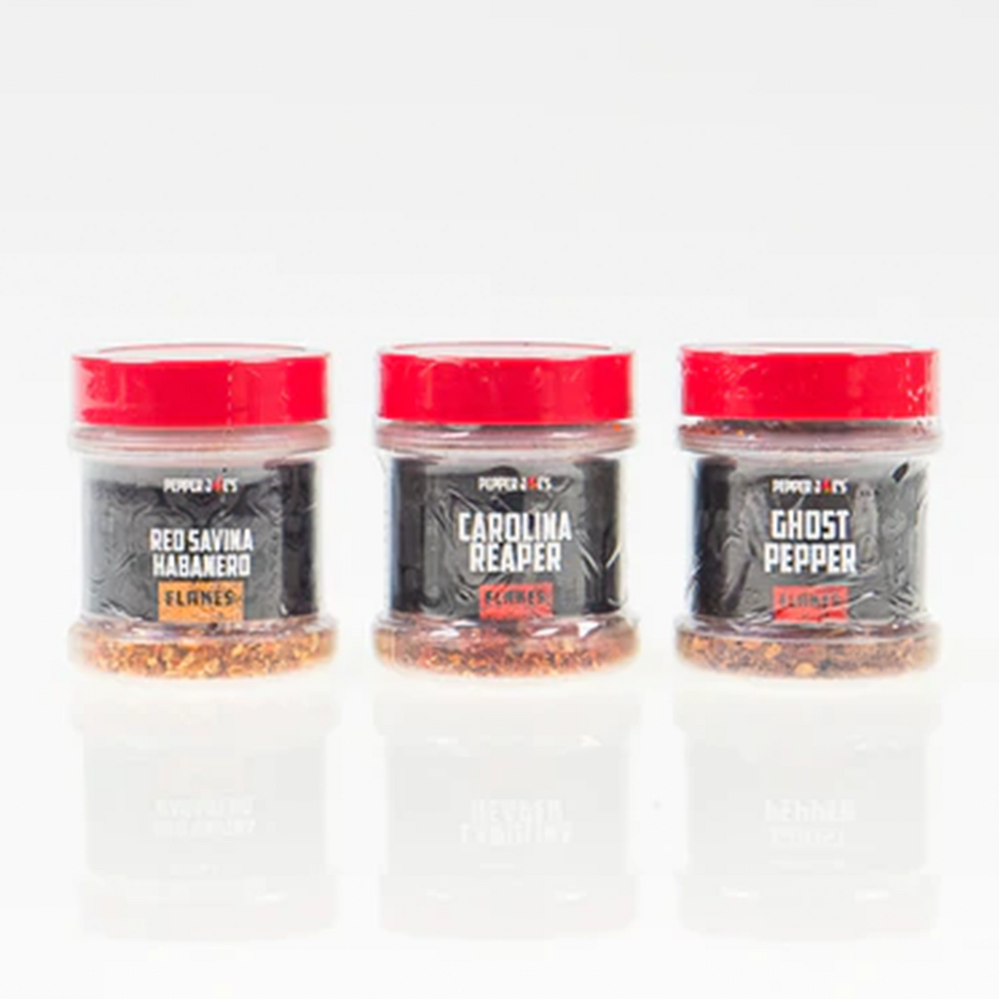 Pepper Joe's world's hottest pepper flakes collection - three hot peppers flakes lined up next to each other 