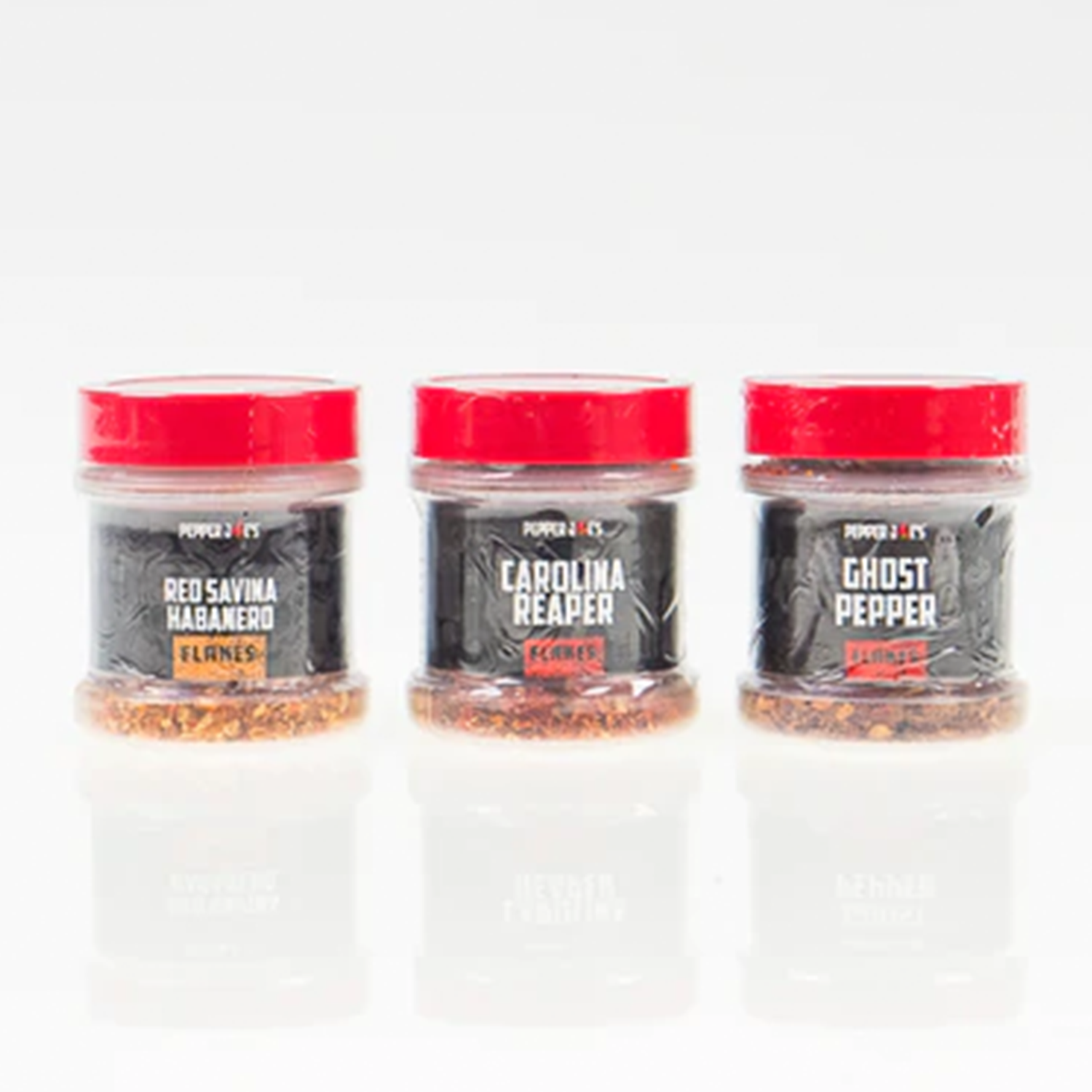 Pepper Joe's world's hottest pepper flakes collection - three hot peppers flakes lined up next to each other 