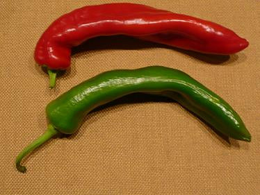Pepper Joe's Zesty 7 Mild pepper seeds - green and red thin slender peppers on wooden table